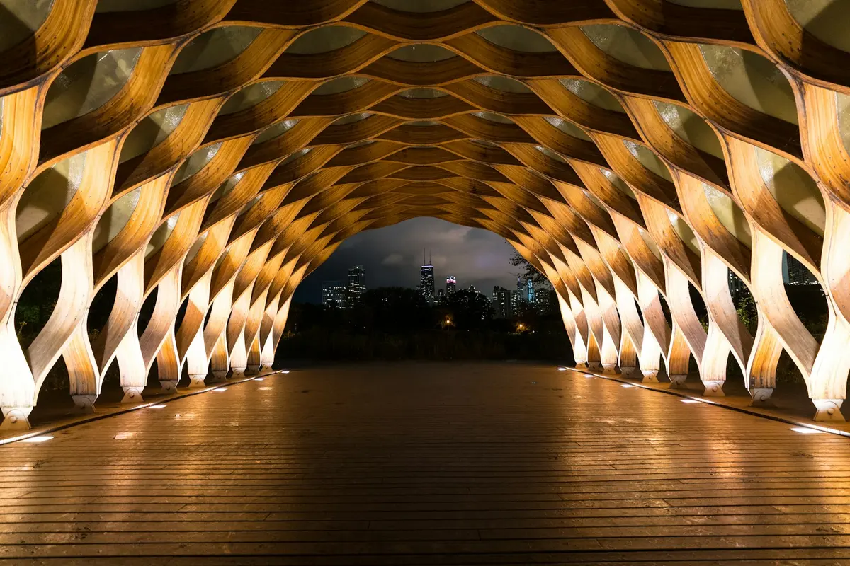 Timber community pavilion lit at night